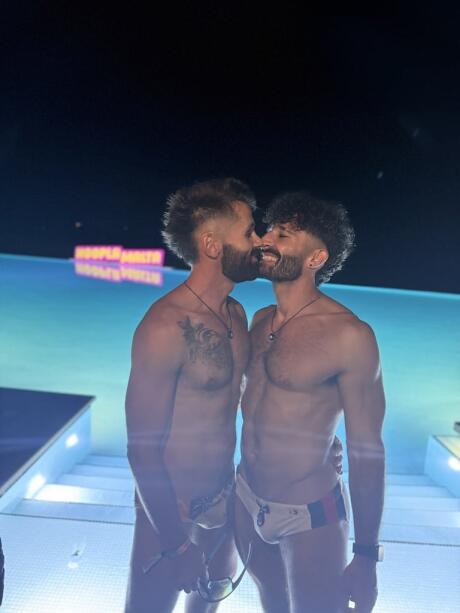 Gay couple kissing at the Hoopla Malta Cafe Del Mar Pool Party.