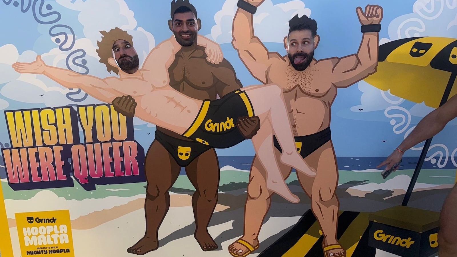 Grindr Hoopla Malta beach boys sign at Little Amier Beach.