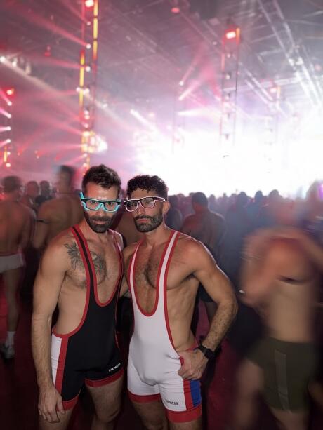 Gay couple Nomadic Boys in singlets at La Demence gay party in Brussels.