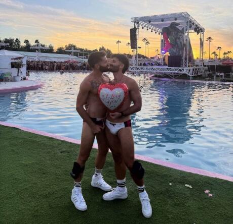 Gay couple kiss at Ocean Tropicana pool party Maspalomas Winter Pride.