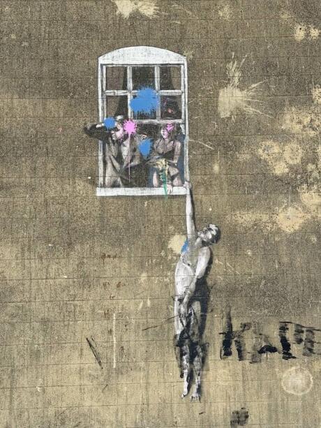 Banksy Well Hung Lover artwork in central Bristol.