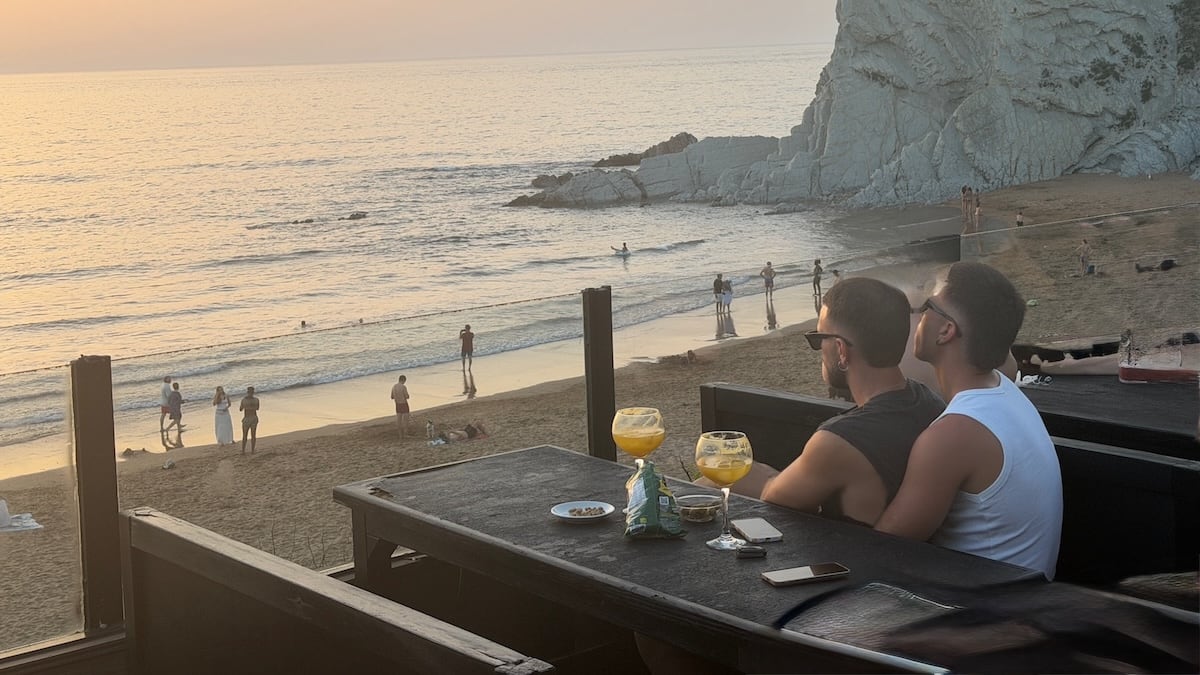 Gay couple at La Salvaje watching the sunset.
