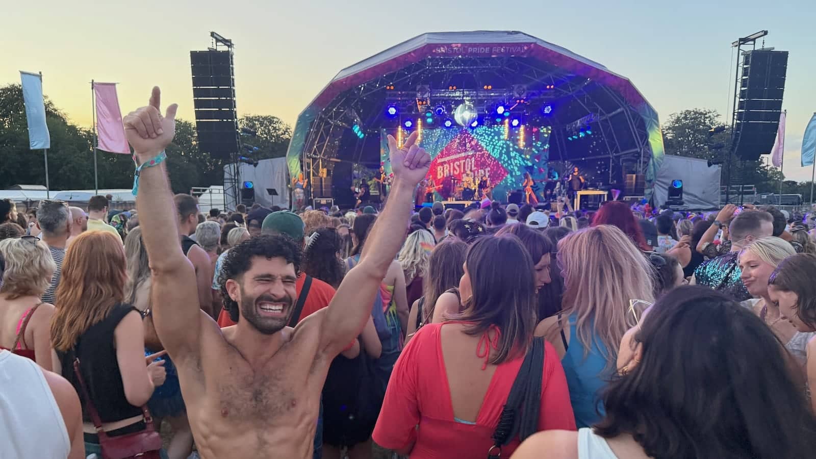 Stefan with his hands in the air at the Bristol Pride festival at the Downs.