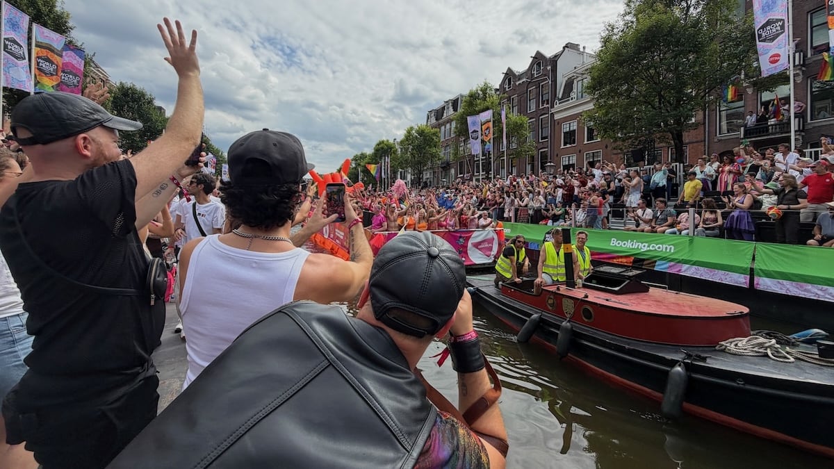 Crowd watching Amsterdam WorldPride on the canal.